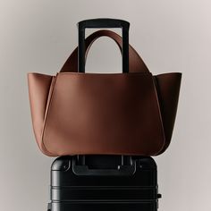 A sophisticated work and travel bag hybrid with an integrated luggage sleeve, a 14” laptop sleeve, and built-in organizational compartments and pockets, crafted in fine-grained Italian leather. Satchel Backpack, Work And Travel, Travel Jewelry Case, Backpack Travel Bag, Wallet Organization, Zippered Tote, Mini Heart, Zip Wallet, Mini Tote