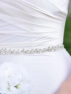 the bride's belt is adorned with crystal stones