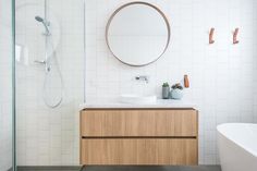 a bathroom with a sink, mirror and bathtub