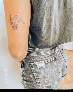 a woman with a small tattoo on her arm