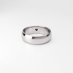 A gently domed Sterling Silver ring band, with a tiny heart. The ❤ could be placed either on the outside or hidden on the inside of the ring band. Please carefully review the full item description below and our Shop Policies. ✓ FREE Laser Engraving Inside Band ✓ FREE Shipping (US Only) ✓ Made to Order in-house (NJ, USA) ✓ Certified 100% Recycled Sterling Silver CUSTOM ITEM MADE TO ORDER ✿ This is a custom made-to-order item. It will be made especially for you and the sale is final. Please double Classic Heart Ring With Polished Finish For Promise, Ring With Heart, Make Your Own Ring, Engraved Engagement Ring, Mens Gold Wedding Band, Alternative Engagement Ring, Sterling Silver Promise Rings, Silver Heart Ring, Sterling Silver Rings Bands