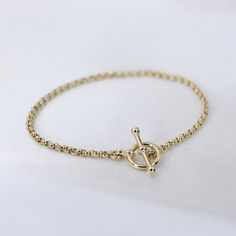 "14K GoldToggle Rolo Chain Bracelet - 14K Gold 2mm Rolo Chain Bracelet ★ 14K gold 2mm rolo chain ★ 14K gold toggle clasp ★ All components are 14K solid yellow gold The length includes the chain and the closure. Please measure your wrist before you place your order. ** How to choose a correct size of bracelet. 1. Measure your wrist below the wrist bone using a flexible tape measures, a string or a strip of paper. 2. If using a string or a strip of paper, mark length. Then, measure it with a ruler Classic Gold Chain Bracelet With Rolo Chain, Yellow Gold Plated Bracelet With Toggle Clasp, Yellow Gold-plated Bracelet With Toggle Clasp, Timeless 14k Gold Chain Bracelet With Spring Ring Clasp, Elegant Gold Bracelets With Rolo Chain, Classic Gold Bracelets With Rolo Chain, Yellow Gold Plated Chain Bracelet With Spring Ring Clasp, Luxury Gold Bracelet With Cable Chain, Gold Chain Bracelet For Everyday