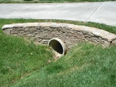 there is a stone tunnel in the grass