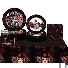 a table topped with plates and bowls covered in halloween themed artwork on it's sides