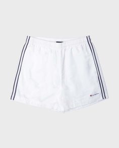 This one's for y2k sportswear lovers. These shorts are genuine champion from the early 2000s. Shorts are white and have grey/navy coloured striped sides. Has two front hand pockets and elasticated drawstring waistband. Iconic champion logo is printed near hem of left pant leg. Has inner netted layer for a comfy breathable fit. Good vintage condition- some slight discolouring and colour fading. Waist 31" Inseam 4.5" L Summer Sportswear Shorts With Side Stripes, Sporty Cotton Athletic Shorts With Three Stripes, Sporty Three Stripes Athletic Shorts, Sporty Three-stripe Athletic Shorts, Streetwear Athletic Shorts With Three Stripes, Streetwear Shorts With Three Stripes, Cotton Shorts With Side Stripes, White Sports Shorts With Side Stripes, Sporty Shorts With Side Stripes