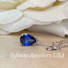 "The pendant pictured is a lab created blue sapphire #6864 -Approximate total carat weight: approx. 2.00ctw diamond equivalent -Center Stone Size: 10x7mm - approx. 2.00ct diamond equivalent -Center Stone Shape: pear -Gem Type: lab created sapphire -Stone Clarity: VS2 -Stone Color: Blue -Moh's Scale: 9 hardness -Metal Type and Purity: 14k yellow gold -Setting: 3 prong basket design -Chain: delicate 14k gold chain / heavier option with lobster claw available (use dropdown to select) -Country of Ma Pear Shaped Sapphire Necklace As Gift, Pear Shaped Sapphire Necklace For Gift, Pear-shaped Blue Diamond Jewelry, Pear-shaped Sapphire Necklace Gift, Blue Pear-shaped Diamond Jewelry, Blue Pear-shaped Birthstone Jewelry, Fine Jewelry Sapphire Teardrop Pendant, Sapphire Teardrop Pendant Fine Jewelry, Sapphire Drop Necklace With Gemstone