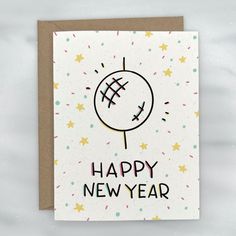 a happy new year card with an image of a ball on it and stars in the background