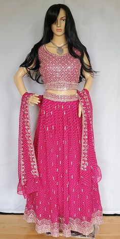 Shop for this beautiful pink colored lehenga in bandini print with croptop. This lehenga comes with satin lining and cancan. Available Size - L (40) Sleeves available ( Please check inside the dress for sleeves ) There may be minor variations in the color, the texture of the product. Color/textures show differently based on lighting. Bollywood Style Pink Sets With Gota Work, Pink Gota Work Sets For Navratri, Pink Sets With Gota Work For Navratri, Bollywood Style Bandhani Print Sharara For Reception, Pink Georgette Choli With Traditional Drape, Pink Anarkali Choli With Gota Work, Anarkali Choli With Bandhani Print For Reception, Pink Mirror Work Sets For Navratri, Pink Sets With Mirror Work For Navratri