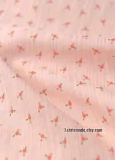 a pink fabric with small flowers on it