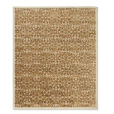 a brown and white rug with an intricate design on the bottom, in front of a white background