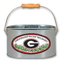 a metal bucket with a green bay packers logo on the side and a wooden handle