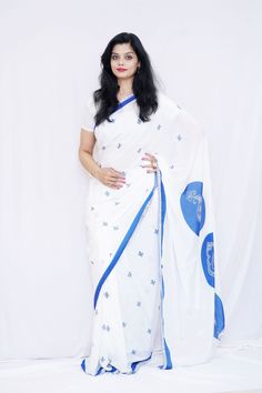 Wearing this beautiful crepe saree will help you unleash your inner diva. The edges of the plain white saree are embellished with a simple yet graceful blue border. Its peaceful white and the blue combination will help you feel peaceful and serene with yourself. To make it look the brightest, dress it up with complementing accessories and stilettos. Specifications: 1) Blouse Color- White & Blue 2) Blouse Length-80 cm(Unstitched) 3) Saree Length-6.5 m 4) Care Instructions- Dry Clean only. 5) Saree Colors Available- White color saree with blue design & blue color saree with white design 6) Colors available-white and blue 7) Width-45 inches 8) Fabric type- Crepe 9) Print Type- Digital Print 10) Brand name- Mudita by Lejina 11) Conceptualized and Created in- India 12) Make sure- You are not wa Traditional White Pre-draped Saree With Embroidered Border, Blue Pre-draped Saree With Printed Motifs, Blue Georgette Dupatta With Printed Motifs, White Pre-draped Saree With Dupatta For Navratri, Unstitched Blue Saree With Printed Motifs, Unstitched Blue Digital Print Saree, Unstitched Blue Saree With Digital Print, Blue Pre-draped Saree With Printed Motifs For Festive Occasions, White Pre-draped Saree With Cutdana For Navratri