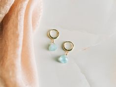 These genuine blue aquamarine hoop earrings would make a perfect gift. Comes in a gold-pressed foil jewelry box and is ready to be gifted.  Aquamarine is the birthstone for the month of March. -------------------------------------- ALL AQUAMARINE JEWELRY  https://etsy.me/3DCL16F AQUAMARINE EARRINGS https://etsy.me/30IhyKf BIRTHSTONE EARRINGS https://etsy.me/3x5L5JE ------------- MATERIAL Genuine 8mm Aquamarine -------------------------- PROCESSING TIME 1 Business Day ------------------------ EAR WIRE OPTIONS: Gold Vermeil Sterling Silver Click Shop to See More Semi-precious Stones Available: Garnet (January) Amethyst (February) Aquamarine (March) Clear Quartz (April) Emerald (May) Moonstone (June) Ruby (July) Peridot (August) Sapphire (September) Rose Quartz (October) Citrine (November) To Fine Jewelry Teardrop Hoop Earrings As Gift, Hypoallergenic Briolette Earrings As A Gift, Hypoallergenic Briolette Earrings For Gift, Blue Small Hoop Jewelry For Anniversary, Blue Fine Jewelry Huggie Earrings As Gift, Blue Huggie Earrings As Gift, Dainty Gemstone Hoop Earrings As Gift, Blue Fine Jewelry Huggie Earrings For Gift, Blue Hypoallergenic Huggie Earrings Gift