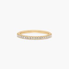 a yellow gold band with white diamonds