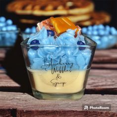 a small glass bowl filled with blue and yellow candies