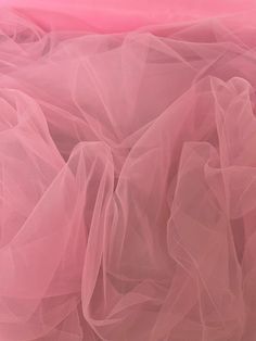 pink tulle fabric is shown in close up