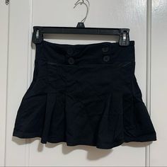 Black Mini Skirt With Button Detail. Never Worn. Black High Waist Mini Skirt With Buttons, High Waist Black Mini Skirt With Buttons, Black Buttoned Mini Skirt, Casual Black Skirt With Button Closure, Black Mini Bottoms With Buttons, Black Mini Length Bottoms With Buttons, Black Mini Skirt With Button Closure, Casual Mini Skirt With Button Closure For Night Out, Casual Skirt With Buttons For Night Out