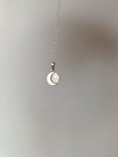 "This sterling silver pendant with a crescent moon is a handmade piece and  unique.  Each moon has its own special shape, so there are no two alike. If you prefer a specific position for the moon, please write to me. Additionally, the silver chain is adjustable, allowing you to wear it at your preferred length, between 40 and 45 cm. It's the perfect accessory to add a special touch to your unique style. To make this pendant, we use the highest quality silver sourced ethically from European mines Silver Pendant Jewelry With Sun And Moon Design, Celestial Silver Jewelry With Round Pendant, Celestial Style Silver Round Pendant Jewelry, Elegant Moon Shaped Sterling Silver Necklace, Celestial Crescent Sterling Silver Jewelry, Sterling Silver Sun And Moon Pendant Charm Necklace, Sterling Silver Charm Necklace With Sun And Moon Design, Sterling Silver Pendant Necklace With Sun And Moon Design, Spiritual Moon Shaped Silver Jewelry