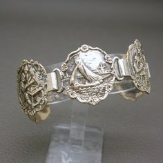 Antique Dutch handcrafted 835 silver bracelet, dating to 1920s. The bracelet is crafted of five elaborately detailed medallions, which are featuring different old Dutch genre scenes from the paintings of Jan Stein.  Beautiful and rare piece of jewelry with lots of individual character, suitable for any occasion, will look very stylish with modern outfit. The bracelet will be shipped in a gift box. Length:  7" (18 cm) - it would fit a medium wrist. Bracelet width: 1 1/8" (2.9 cm)  Weight: 30.7 gr Traditional Dutch Jewelry, Vintage Brass Jewelry With Historical Design, Ornate Stamped Bracelets For Formal Occasions, Antique Hallmarked Sterling Silver Bracelet, Collectible Sterling Silver Antique Bracelet, Antique Silver Brass Bracelet, Antique Medallion Jewelry With Historical Design, Vintage Ceremonial Jewelry With Historical Design, Antique Adjustable Jubilee Bracelet