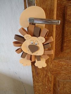 a paper lion hanging on a door handle