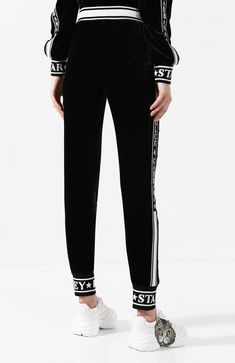 Achieve the ultimate in athleisure style with Dolce & Gabbana's Fluid Velvet Jogging Pants. Crafted from luxe a signature floral bloom design, these pants feature an elasticated waistband, gathered ankles, side zipped pockets, stripe detail, and jacquard branded trimming. Show off your sport-luxe look comfort style. Sport Luxe, Bloom Design, Athleisure Style, Sports Luxe, Athleisure Fashion, Jogging Pants, Lacing Sneakers, Comfort Style, Black Logo