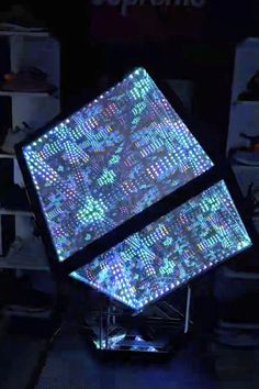 an illuminated cube in the middle of a room