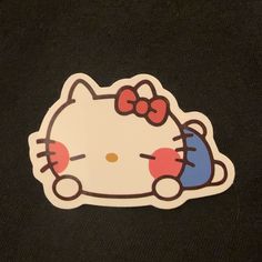 a hello kitty sticker on a black shirt