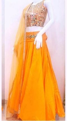 https://www.indiabazaaronline.com/mirror-work-navratri-lehenga-in-orange-art-silk-wj007504.html Orange Sharara For Wedding, Navratri Chandbali-shaped Tissue Silk Lehenga, Orange Traditional Drape Set With Cutdana, Tissue Silk Sets For Wedding And Navratri, Wedding Navratri Tissue Silk Sets, Orange Raw Silk Choli, Navratri Choli With Gota Work In Tissue Silk, Silk Orange Anarkali Set With Pallu, Orange Silk Anarkali Set With Pallu