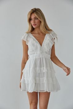 Embrace your femininity in the Xena Flutter Sleeve Babydoll Mini Dress! This mini dress features flutter sleeves, a V-neckline, tiered ruffle skirt, and a triple clasp bust detail. Available in white and blue. Pair with some heels to complete the look! Details 75% Rayon, 25% Nylon Lining: 100% Polyester Elastic waistband Elastic band sleeves Hand wash cold