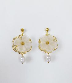 *Use discount FOURITEMS to get 10% off when you purchase 4 or more items (valid with jewelry, ceremony item, etc) * Designed and handcrafted in the Philippines by Filipino women artisans * Gold-plated brass studs with secure lock backs * Made of stainless steel gold plated hardware, handcrafted silk organza flowers characterized with sheerness that complements one's elegance, and baroque South Sea pearls, locally sourced from Cebu City in the Philippines to support traditional crafts * 2 inches in length, lightweight to wear all day * Each piece features 'intentional imperfections' - variations in exact size, cut, color, texture, and patterns. This adds to the individuality and unique story of each piece. Pearls are baroque and irregularly shaped, just as nature intended and may not exactl Filipino Pearl Jewelry, Traditional Filipino Jewelry, Filipino Earrings, Filipino Costume, Filipino Jewelry, Mama Jewelry, Ancient Fashion, Market Outfit, Philippine Islands