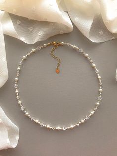 "This necklace features pearlescent, matte clear, white, and 24k gold filled seed beads. It also contains clear crystal beads. As well as faux pearls.  Length: 15\" inches Seed Bead Size: 11/0, 4mm, 6mm Adjustable: Each necklace has a 2.5\" gold filled lobster clasp extender Strung on: Non-Stretchy Beading Thread" Adjustable Gold Crystal Necklace For Wedding, Delicate Gold Beaded Crystal Necklace, Delicate Gold Beaded Crystal Necklaces, Gold Crystal Necklace With Pearl Chain, Pearl Beaded Necklaces For Wedding With Tiny Beads, Aurora Necklace, قلادات متدلية, Seed Bead Choker, Beaded Jewelry Necklaces