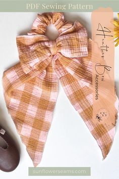 an orange and white checkered bow on top of a pair of brown slippers