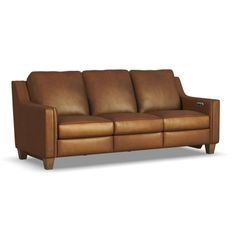 a brown leather couch sitting on top of a white floor