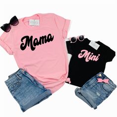 Mama and Mini set of 2 matching tees! Professionally screen printed. Retro style font. MAMA is printed on a standard adult unisex tee made of 100% cotton. Shirt color is Pink. Print color is Black. Fits true to size. Unisex sizing. We recommend ordering the same size you normally wear in an adult unisex shirt. If you want more of a fitted look, order one size down. Refer to Product Images for Size Chart with chest measurements. MINI is printed on your choice of a one-piece bodysuit for baby or a Trendy Pink T-shirt With Name Print, Cute Family Shirt With Letter Print, Cute Family T-shirt With Letter Print, Matching Family Letter Print T-shirt, Fun Letter Print Tops For Family Occasions, Cute Cotton T-shirt With Name Print, Cute Family Shirt With Name Print, Family Funny Print Graphic Tee, Family Matching Tops With Funny Text