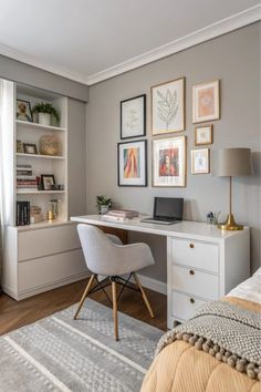 a bedroom with a desk, chair and pictures on the wall