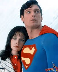 the man and woman are dressed up as superman