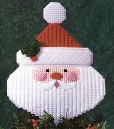 a santa clause ornament hanging from a tree