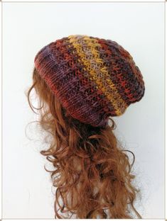 a close up of a knitted hat on top of a woman's head