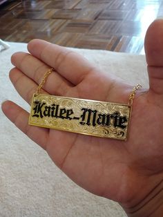 "Nameplate necklace with your name or couple names customized. The plate is made with 14/20 yellow gold filled on both sides. The thickness is 1.02mm. The plate measures 1\"wide by 3\" long. The maximum number of letters is 9. The letters are engraved an enameled in Old English. The chain is attached to the plate with circle bails. The chain is a gold filled 2.8mm double rope with a lobster claw. The background design is hand engraved with Victorian scrolls. The processing time is 2 weeks. Backg Engraved Bangle Bracelet, Name Plate Necklace, Engraved Bangle, Necklace Name, Nameplate Necklace, Name Plates, Plate Necklace, Photo Bracelet, Old English