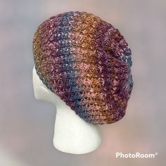 a crocheted hat is shown on a mannequin head