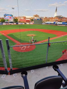 a baseball game in progress with the pitcher throwing the ball to the batter at home plate