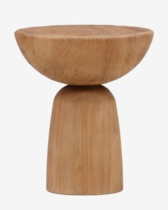 a small wooden stool sitting on top of a white floor