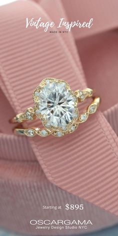 an engagement ring is shown on top of a pink ribbon with the words vintage inspired