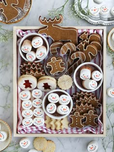 an assortment of decorated cookies and pastries arranged on a table with other holiday treats