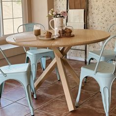 a wooden table with chairs around it