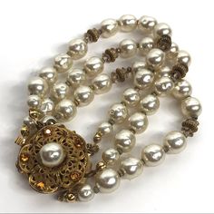 Exquisite Vintage Glass Baroque Pearl Triple Strand Bracelet Signed Miriam Haskell. Three Strands Lavish Creamy White Organically Shaped Beads, With Normal Vintage Wear. Beads Alternate W Tiny Antique Gold Tone Metal Spacers. Secures W A Signed Gold Tone Metal Lace Like Filigree Clasp Accented W Amber Glass Rhinestones. Additional Security Chain Is In Tact. Measures About 7 And 3/4 Inches End To End. 1950s 50s 1960 60s Rare Luxury Designer Fine Vintage Antique Jewelry Artisan Unique Classic Miriam Haskell, Metal Lace, Vintage Antique Jewelry, Strand Bracelet, Amber Glass, Vintage Wear, Baroque Pearls, Creamy White, Bead Bracelet