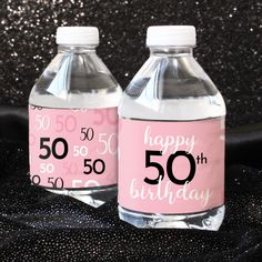 two water bottles with happy 50th and 50 birthday labels on the front one is empty