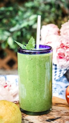 a green smoothie in a glass with a straw