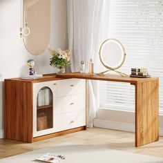 a wooden desk with a mirror and vase on it in a white living room next to a window