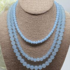 Indulge in the timeless elegance of the Amicae Blue Single Strand Necklace - a handcrafted crystal glass masterpiece that exudes sophistication with every single strand - The icy blue hue of the beads brings images of clear winter skies. In contrast, the single-strand design adds a touch of simplicity to this work. Whether you're attending your best friend's wedding or dressing for an important business meeting, the Amicae Blue Necklace will surely be your go-to accessory for that perfect finish Light Blue Single Strand Necklace With Round Beads, Light Blue Round Beads Necklace For Gifts, Light Blue Polished Beads Necklace For Gift, Light Blue Single Strand Jewelry For Jewelry Making, Elegant Blue Necklace With 8mm Beads, Elegant Blue Necklaces With 8mm Beads, Elegant Blue Necklace With Round Beads, Light Blue Gemstone Beads Necklace For Gift, Light Blue Gemstone Beaded Necklace Gift